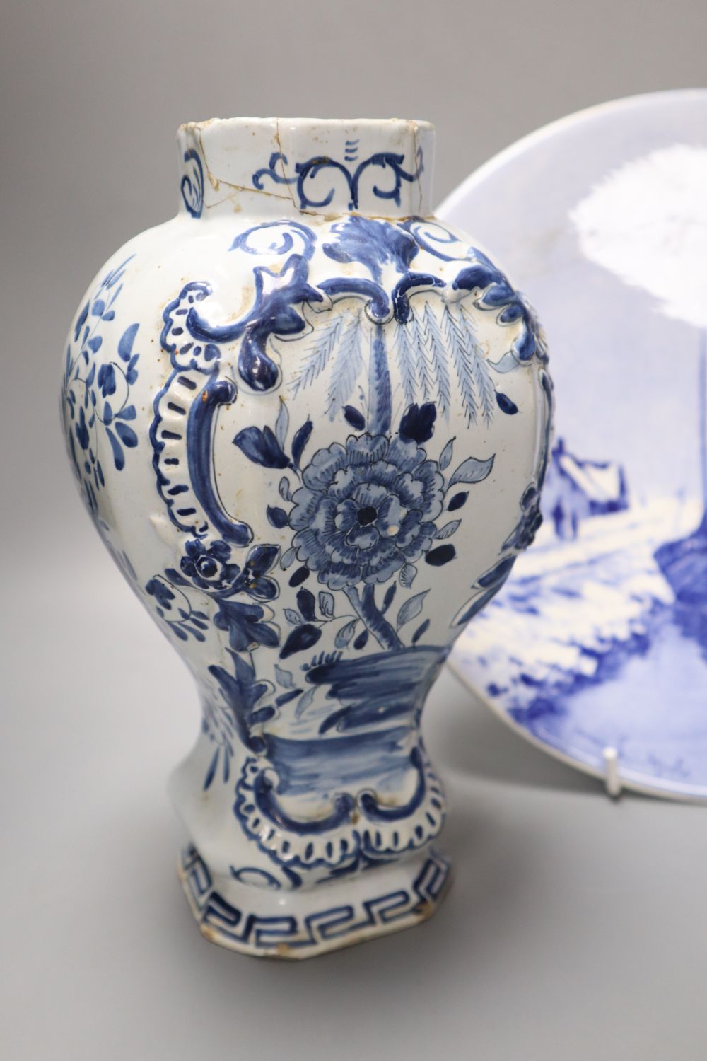 A delftware vase, 22cm, delft vase and a painted wall plate, 26cm